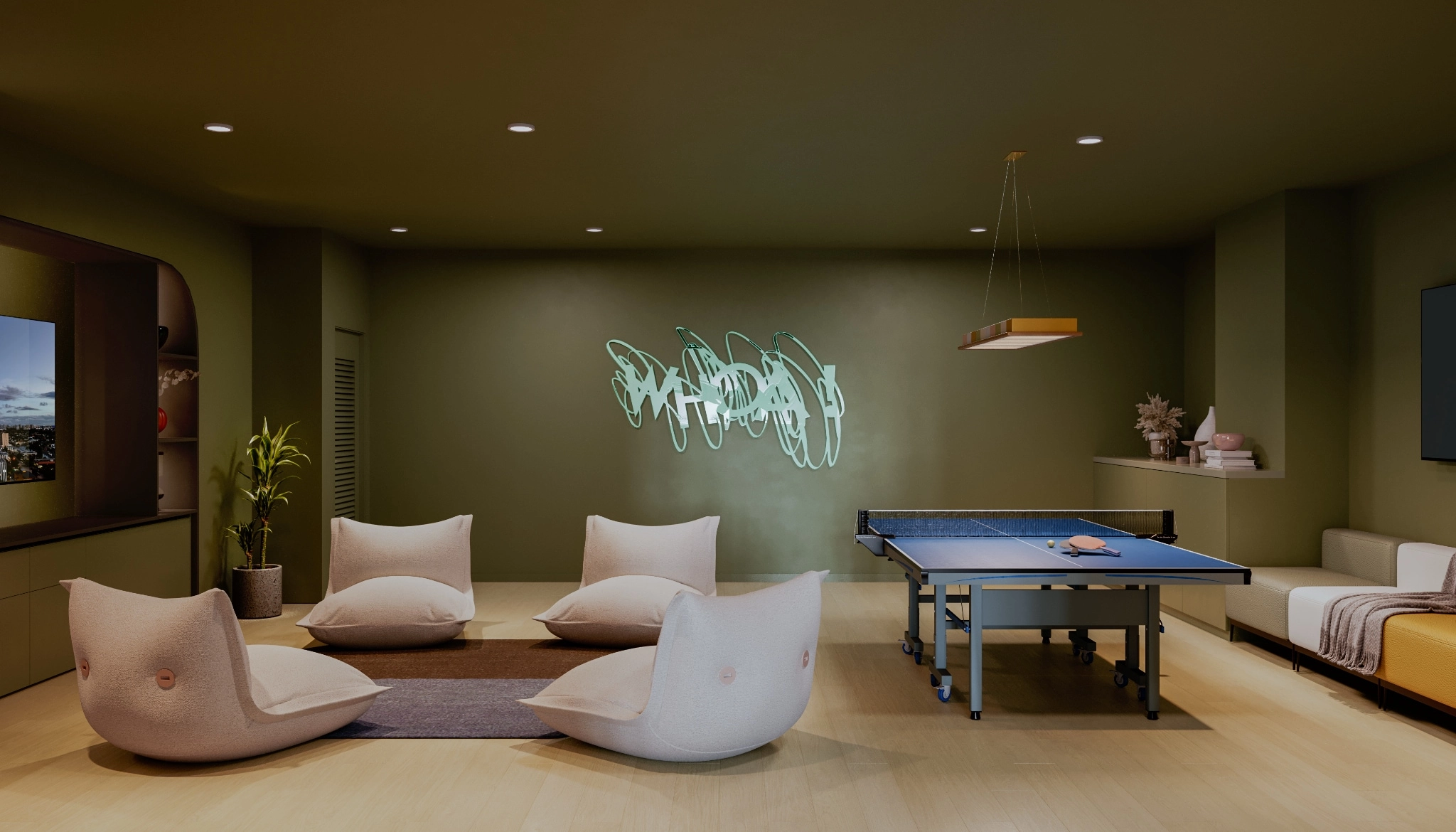 Game room at the Mondrian HB Residences with a big screen tv, low profile chairs and a ping pong table.