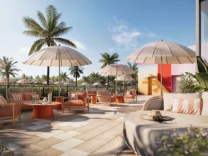 An outdoor patio with umbrella covered seating areas at the Mondrian Hallandale Beach Residences in South Florida.